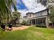 Spacious backyard featuring a sparkling pool, lush greenery, and an outdoor grilling area at 4313 W Vasconia St, Tampa, FL 33629