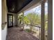 Covered balcony with brick flooring and decorative columns offers a tranquil outdoor space at 4313 W Vasconia St, Tampa, FL 33629