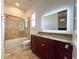 Modern bathroom featuring a granite countertop vanity with illuminated mirror and tiled shower at 4313 W Vasconia St, Tampa, FL 33629