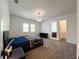 Bright bedroom featuring plush carpeting, a decorative light fixture, and access to the Primary closet at 4313 W Vasconia St, Tampa, FL 33629