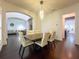 Bright dining room with a modern chandelier, hardwood floors, and an open-concept design at 4313 W Vasconia St, Tampa, FL 33629