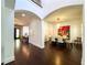 Open-concept living space with a spacious dining area featuring a modern chandelier and hardwood floors at 4313 W Vasconia St, Tampa, FL 33629