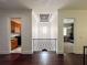 Hallway with hardwood floors featuring a decorative light fixture, transom window, and access to other rooms at 4313 W Vasconia St, Tampa, FL 33629