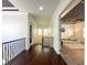 Upstairs hallway boasts hardwood floors, black iron railing, and trim at 4313 W Vasconia St, Tampa, FL 33629