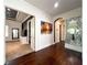 Hallway with hardwood floors, stylish accents, and access to a large main bedroom at 4313 W Vasconia St, Tampa, FL 33629