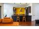 Kitchen featuring black cabinets, stainless steel appliances, black countertops, and a bright yellow accent wall at 4313 W Vasconia St, Tampa, FL 33629