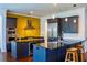 Kitchen featuring dark blue cabinets, stainless steel appliances, black countertops, and an eat-in center island at 4313 W Vasconia St, Tampa, FL 33629