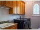 Convenient laundry room with a sink, granite countertop, and newer washer and dryer at 4313 W Vasconia St, Tampa, FL 33629