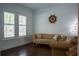Cozy living room featuring hardwood floors, a comfortable sofa, and natural light from large windows at 4313 W Vasconia St, Tampa, FL 33629