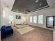 Large main bedroom featuring neutral decor, tray ceiling, ceiling fan, and three windows at 4313 W Vasconia St, Tampa, FL 33629