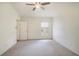 Neutral bedroom with carpet, door, and window providing natural light at 4514 Arizona Sun Ct, Valrico, FL 33594
