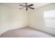 Bedroom features neutral carpeting, ceiling fan, and a window allowing natural light to illuminate the space at 4514 Arizona Sun Ct, Valrico, FL 33594