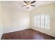 Bright bedroom featuring hardwood floors, ceiling fan and a large arched window at 4514 Arizona Sun Ct, Valrico, FL 33594