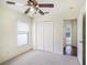 Bedroom boasts neutral carpeting, ceiling fan, double closet, and a window for natural light at 4514 Arizona Sun Ct, Valrico, FL 33594