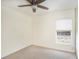 Bedroom features neutral carpeting, ceiling fan, and a window allowing natural light to illuminate the space at 4514 Arizona Sun Ct, Valrico, FL 33594