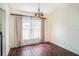 Cozy dining area with wood floors, chandelier, and large window with blinds at 4514 Arizona Sun Ct, Valrico, FL 33594