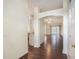 Inviting foyer showcasing elegant archways and gleaming wood floors, transitioning into the kitchen and living areas at 4514 Arizona Sun Ct, Valrico, FL 33594