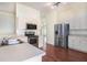 Well-lit kitchen featuring stainless steel appliances, sleek countertops, and hardwood floors at 4514 Arizona Sun Ct, Valrico, FL 33594