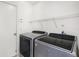 Laundry room with washer, dryer, and storage shelving above at 4514 Arizona Sun Ct, Valrico, FL 33594