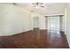 Spacious living room with hardwood floors, ceiling fan, and access to the outside at 4514 Arizona Sun Ct, Valrico, FL 33594