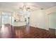 Spacious living room with hardwood floors, a ceiling fan, and an open layout to the kitchen at 4514 Arizona Sun Ct, Valrico, FL 33594