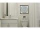 Bright bathroom featuring a white vanity, gray framed art, and a plant on top of the toilet at 4752 Southern Valley Loop, Brooksville, FL 34601