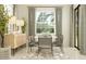 Elegant dining room with a round table, chairs, modern lighting, and large windows at 4752 Southern Valley Loop, Brooksville, FL 34601