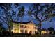 Elegant two-story home exterior with classical columns and manicured landscaping at dusk at 4752 Southern Valley Loop, Brooksville, FL 34601