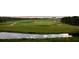 Expansive golf course view featuring lush green fairways, water features, and distant clubhouse; a picturesque setting for golf enthusiasts at 4752 Southern Valley Loop, Brooksville, FL 34601