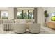 Bright and airy living room with neutral furniture, patterned rug, and large windows with backyard views at 4752 Southern Valley Loop, Brooksville, FL 34601