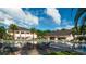 Resort-style pool area with sun loungers, palm trees, and a bar under a bright sky; a relaxing oasis for leisure and entertainment at 4752 Southern Valley Loop, Brooksville, FL 34601