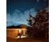 Cozy home exterior illuminated at dusk with a well-kept lawn and garden at 5103 98Th E Ave, Parrish, FL 34219