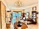 Open living space with a chandelier, flowing into the dining area, creating an inviting atmosphere at 5103 98Th E Ave, Parrish, FL 34219