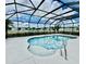 Refreshing pool with a screened lanai, blue water, and a serene backyard view at 5103 98Th E Ave, Parrish, FL 34219