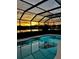 Enclosed pool with a sunset view at 5103 98Th E Ave, Parrish, FL 34219