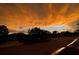Residential street with dramatic orange sunset skies over homes, showcasing a tranquil neighborhood setting at 5103 98Th E Ave, Parrish, FL 34219