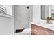 Updated bathroom with a tiled shower, a modern vanity, and black fixtures, offering a sleek design at 603 Amana Ave, Brandon, FL 33510