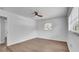 Spacious bedroom with a ceiling fan, wood-look floors, and a bright window offering natural light at 603 Amana Ave, Brandon, FL 33510