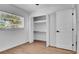 Bedroom featuring wood-look floors, a closet, and a large window providing natural light, for a comfortable living space at 603 Amana Ave, Brandon, FL 33510