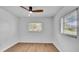 Well-lit bedroom with wood-look flooring and a large window, creating a cozy and inviting atmosphere at 603 Amana Ave, Brandon, FL 33510