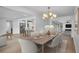 Spacious dining room features a wooden table, chandelier, and view to kitchen and living room at 603 Amana Ave, Brandon, FL 33510