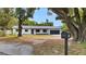 Charming ranch-style home with mature trees, a black mailbox, and a spacious front yard at 603 Amana Ave, Brandon, FL 33510