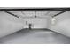 Spacious two-car garage with a concrete floor, white walls, and ample room for parking and storage at 603 Amana Ave, Brandon, FL 33510