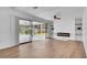 Bright living room with electric fireplace and shelves, leading to a screened-in porch with sliding doors at 603 Amana Ave, Brandon, FL 33510