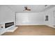 Spacious living area featuring a modern electric fireplace, wood-look flooring, and bright white walls at 603 Amana Ave, Brandon, FL 33510