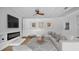 Bright living room with fireplace, ceiling fan, and comfortable seating area at 603 Amana Ave, Brandon, FL 33510
