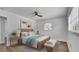 Comfortable main bedroom with wooden bed, ceiling fan, and natural light at 603 Amana Ave, Brandon, FL 33510