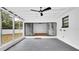 Screened-in patio with wood floors, ceiling fan, and access to the backyard, extending the indoor living space at 603 Amana Ave, Brandon, FL 33510