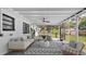 Enclosed sun room with comfortable seating and view to the backyard at 603 Amana Ave, Brandon, FL 33510