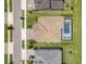 Aerial view of the home showing the roof, driveway, and pool enclosure at 6109 Marsh Trail Dr, Odessa, FL 33556